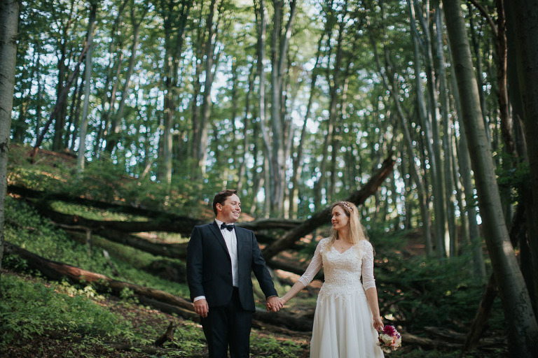 trzymająca się za ręce para młoda w lesie w Gdyni