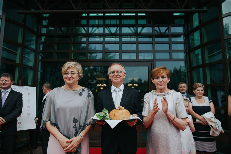 rodzice witają parę młoda chlebem i solą na weselu 
