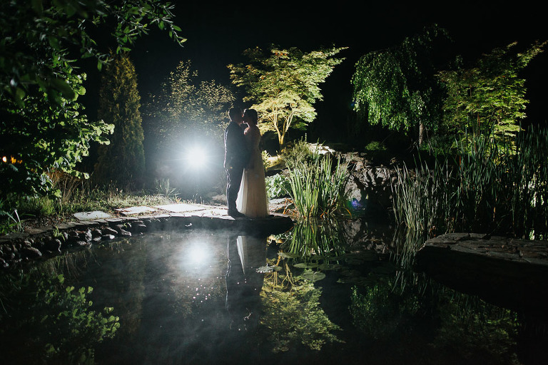 para ślubna w zdjęciu nocnym przy oczku wodnym