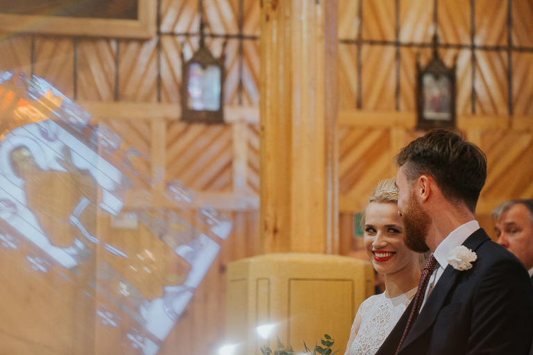 uśmiechnięta pani młoda w trakcie ślubu