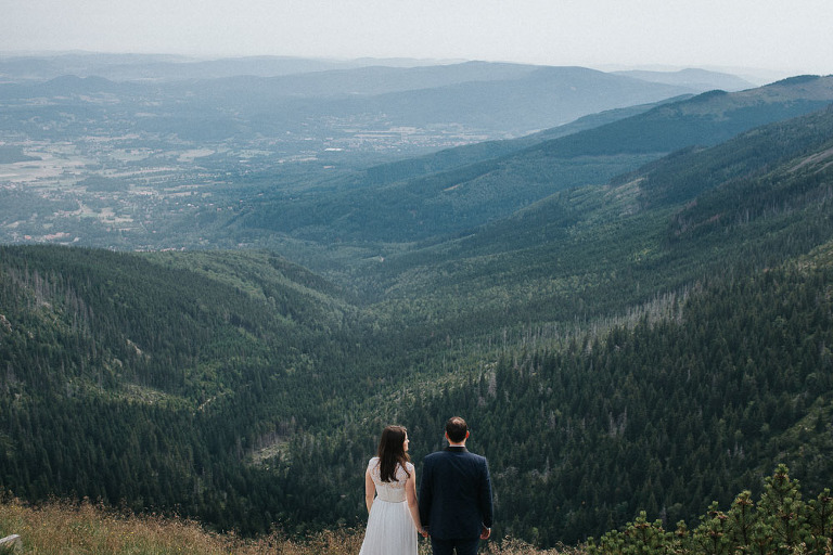 para stojąca na tle gór 