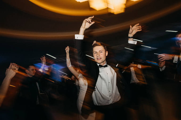 pan młody tańczy na parkiecie 